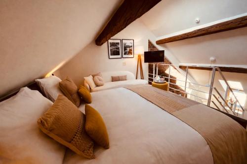 a bedroom with a large bed in a attic at DEUXHOMMES Boutique B&B Massage&Spa in Hasselt