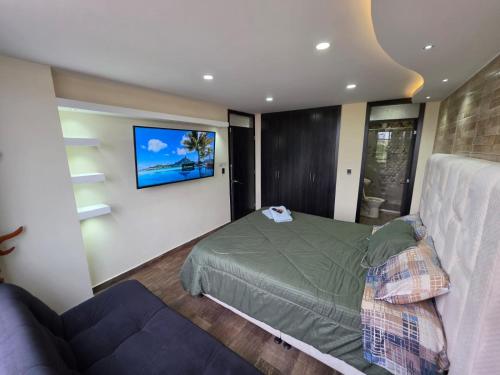a bedroom with a bed and a couch at Torres buambiles 2 in Ipiales