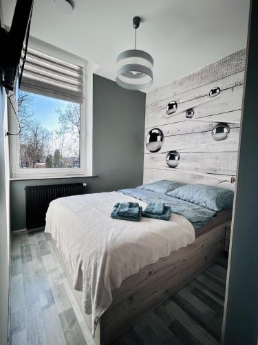 a bedroom with a bed with two towels on it at Chopina Place in Oświęcim