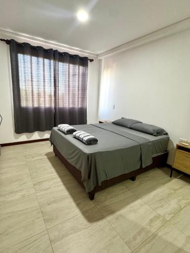 a bedroom with a bed and a large window at Departamento completo en zona Turística de Santa Cruz in Santa Cruz de la Sierra