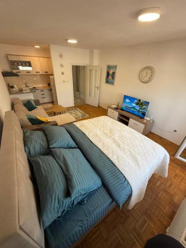 a large bed in a living room with at MAAA Apartman in Tuzla