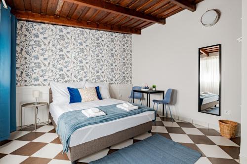 a bedroom with a bed and a checkered floor at T7 Garden guest house in Siófok