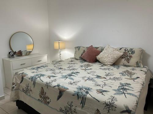 a bedroom with a bed with a blue and white blanket at Casa Antonio in Reynosa