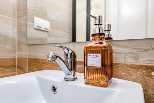 a bottle of soap sitting on top of a sink at T7 Garden guest house in Siófok