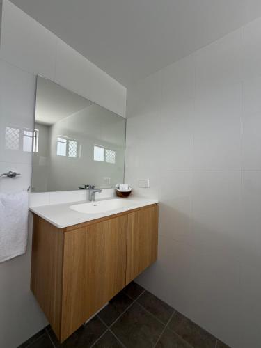 a bathroom with a sink and a mirror at QCWA K P Units in North Ward