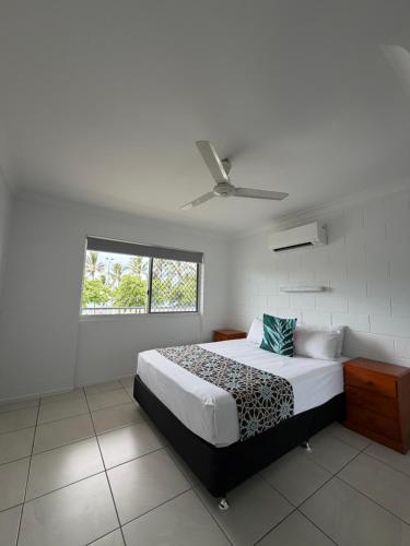a bedroom with a bed with a leopard print blanket at QCWA K P Units in North Ward