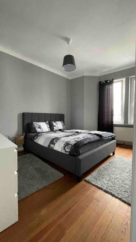 a bedroom with a large bed with a rug at Wohnung Karl-Marx 2 in Trier
