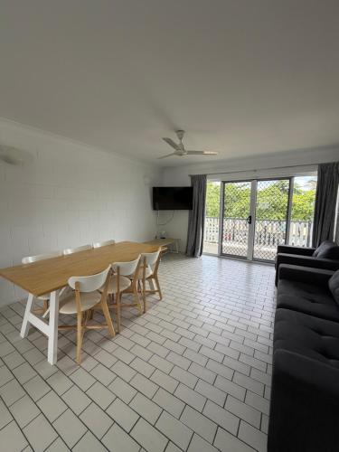 a living room with a wooden table and chairs at QCWA K P Units in North Ward