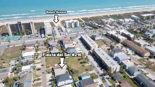an aerial view of the beach in front of a city at Walkable Location - 99 Steps to Beach - Pool apts in South Padre Island