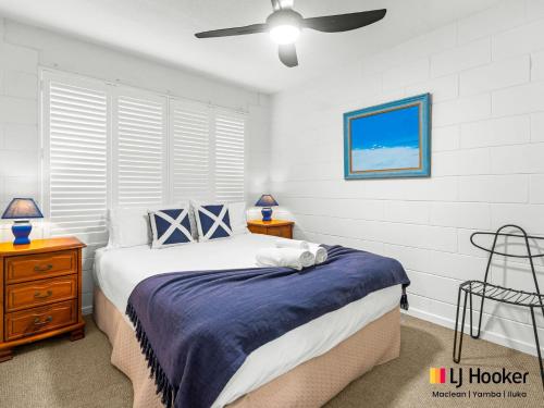 a bedroom with a bed and a ceiling fan at Iluka Villa 2 in Iluka