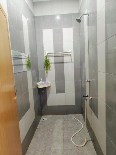 a bathroom with a shower and a sink at Redhousehomestay in Kota Bharu