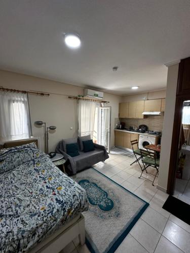 a bedroom with a bed and a living room at Studio Kastra in Thessaloniki