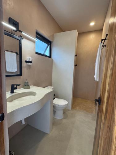 a bathroom with a sink and a toilet at SEA Villa With Private Plunge Pool in Todos Santos