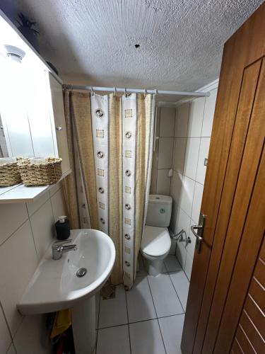 a bathroom with a sink and a toilet at Studio Kastra in Thessaloniki