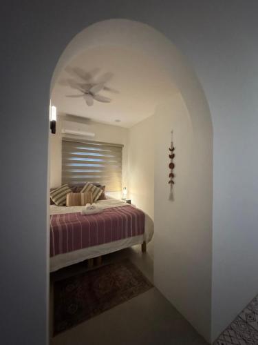 a bedroom with a bed with a ceiling fan at SEA Villa With Private Plunge Pool in Todos Santos