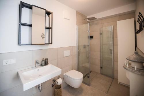 a bathroom with a sink and a toilet and a shower at Penthouse & Forest Retreat - near city in Bornheim