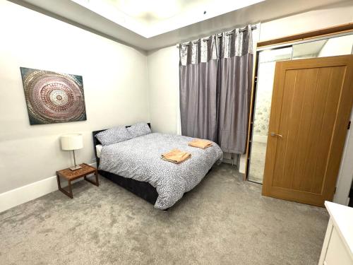 a bedroom with a bed and a sliding glass door at meze in Perth