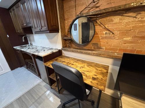 a counter with a mirror on a brick wall at Spadina Boutique Rooms in Toronto