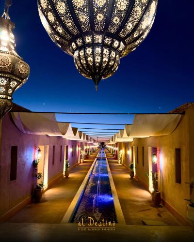 a large chandelier hangs over a long alleyway at night at Al destino Resort Marrakech in Marrakesh