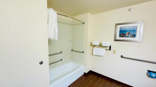 a bathroom with a white tub and a sink at Black Gold Suites Tioga in Tioga