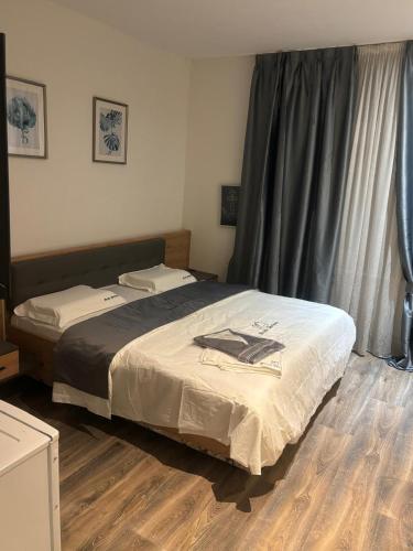 a bedroom with a bed and a wooden floor at Kurvilla Apartments in Landstuhl