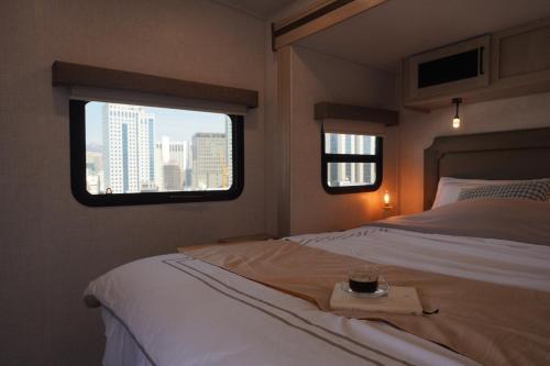 a bedroom with a bed and a window with a tray on it at NamSan203 Guest house in Seoul
