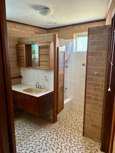 a bathroom with a sink and a toilet and a shower at Kite House in Guilderton