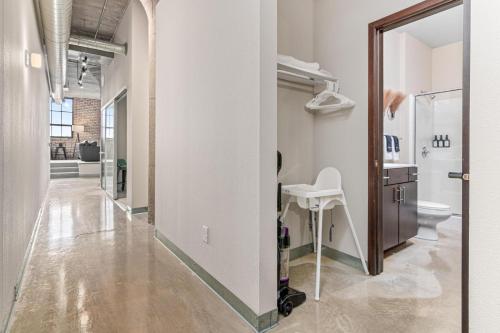 a hallway with a bathroom with a toilet and a mirror at 2KBD2BA Steps from Target Center+GYM+KTCHN+LNDRY in Minneapolis