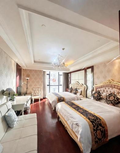a hotel room with two beds and a desk at Pu Yu Apartment in Shanghai