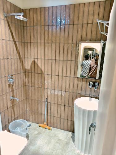 a bathroom being remodeled with a toilet and a mirror at Spontrail Hostel in Rishīkesh