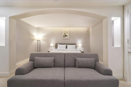 a large bedroom with a bed and a couch at Page 9 Hotel in Seoul