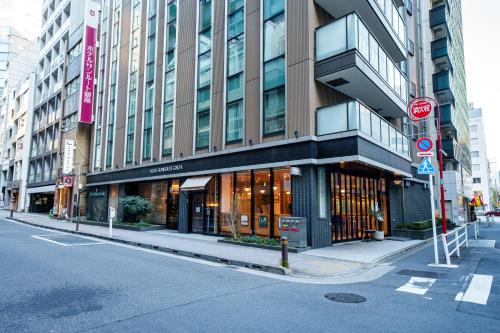 a building on a city street with a do not enter sign at Hotel Sunroute Ginza in Tokyo