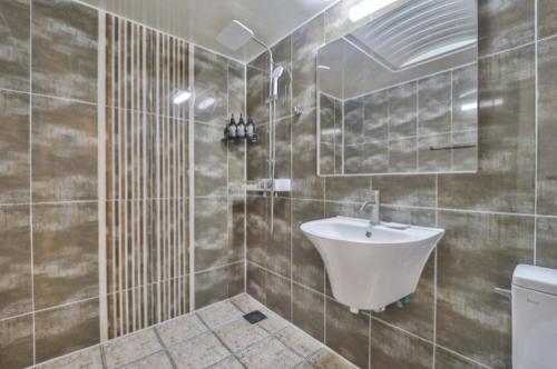 a bathroom with a sink and a toilet in it at Page 9 Hotel in Seoul