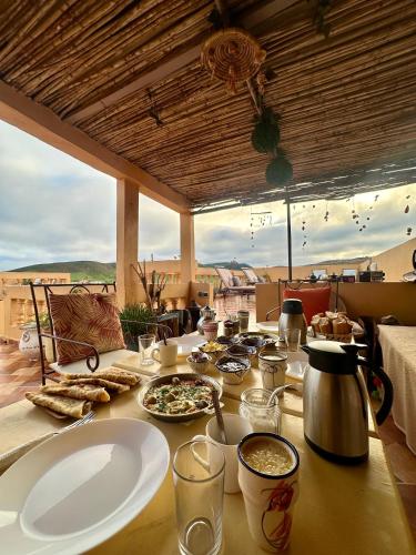 a table with plates of food on top of it at Tayafut ApartmentTerrace in Mirleft
