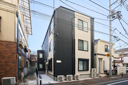 a black building on the side of a street at Reberty Haneda in Tokyo