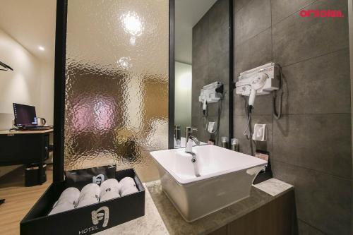 a bathroom with a sink and a box of towels at 월호텔 in Cheonan