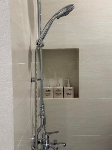 a shower with a shower head in a bathroom at La May Boutique hotel in Ninh Binh