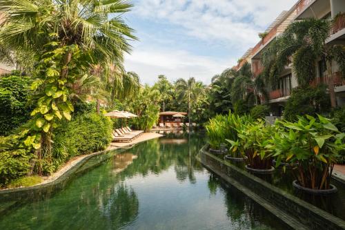 a canal in a resort with palm trees at TUI BLUE Angkor Grace Wellness Resort in Siem Reap