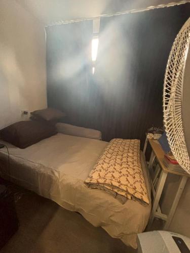 a bedroom with a bed and a fan at The8collaction in Bangkok