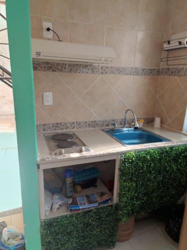 a kitchen with a sink and a counter top at Departamento Acapulco tres mares in Acapulco