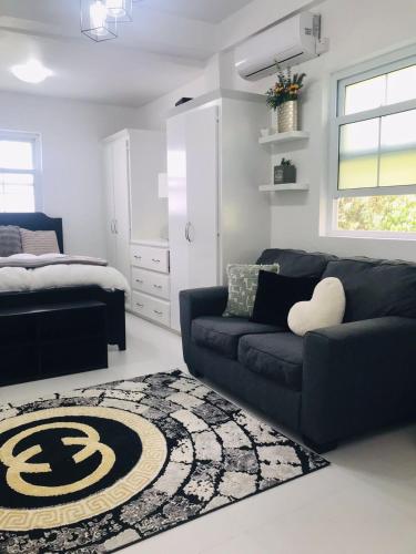 a living room with a couch and a bed at Casa Bonita GLAM in Castries