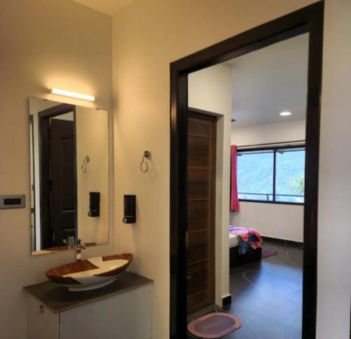 a bathroom with a sink and a mirror at Green Lounge in Munnar