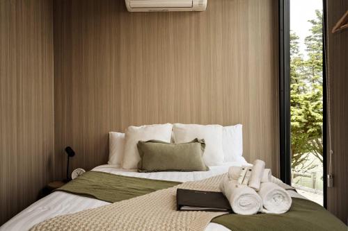 a bedroom with a large bed with towels on it at Sunset Hill by Tiny Away in Dollar