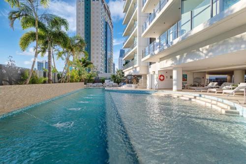 a swimming pool in the middle of a building at The Brass Pineapple Surfers Paradise 4217 - Wyndham Surfers Paradise in Gold Coast