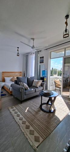 a living room with a couch and a table at Homely studio Apartment 2 in Mombasa