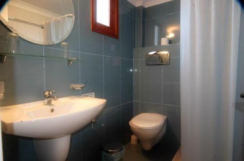 a bathroom with a sink and a toilet at Hotel Navarone in Petrochori