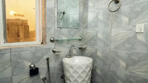a bathroom with a sink and a mirror at Peace Continental Hotel in Islamabad