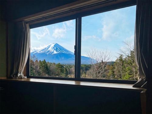 a view of a mountain through a window at Hanamizuki in Yamanakako