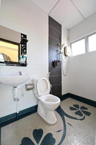 a bathroom with a toilet and a sink at First Star Homestay - Self Check In in Kluang