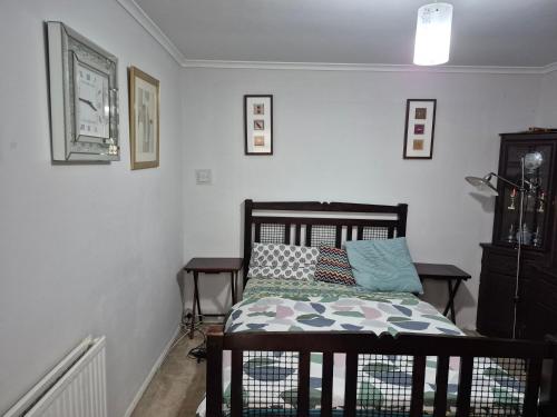 a bedroom with a bed with a pillow on it at The Garden view Nook in Ash